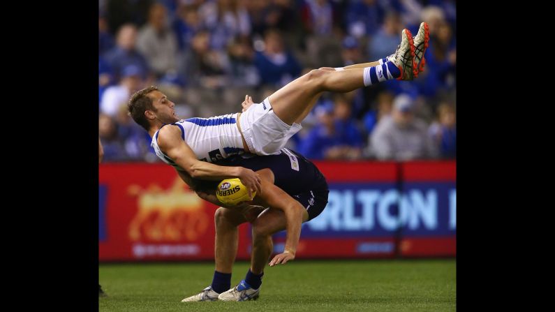 Jamie Macmillan of the North Melbourne Kangaroos marks over Nick Suban of the Fremantle Dockers during an Australian Football League match Sunday, August 23, in Melbourne.