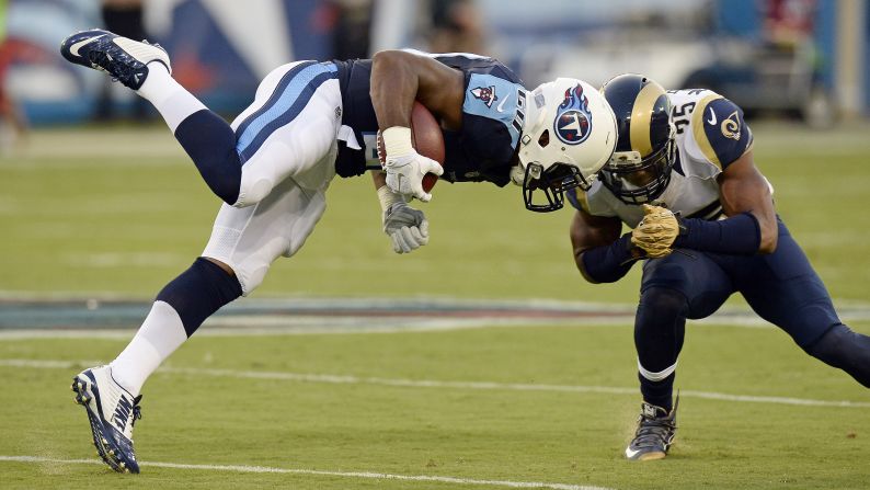 Tennessee Titans running back Bishop Sankey, left, collides with St. Louis safety T.J. McDonald during an NFL preseason game in Nashville, Tennessee, on Sunday, August 23.