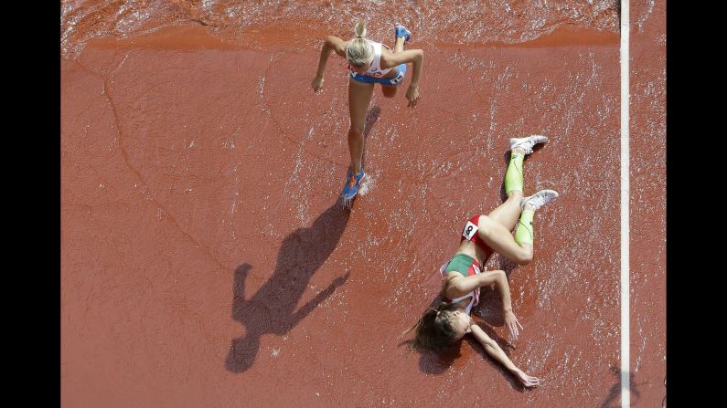 Belarussian athlete Svetlana Kudelich falls during a steeplechase race at the World Championships on Monday, August 24.