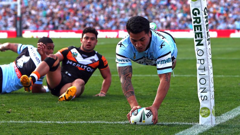 Sosaia Feki scores a try for the Cronulla Sharks during a National Rugby League match in Sydney on Saturday, August 22. Cronulla defeated the Wests Tigers 40-18.