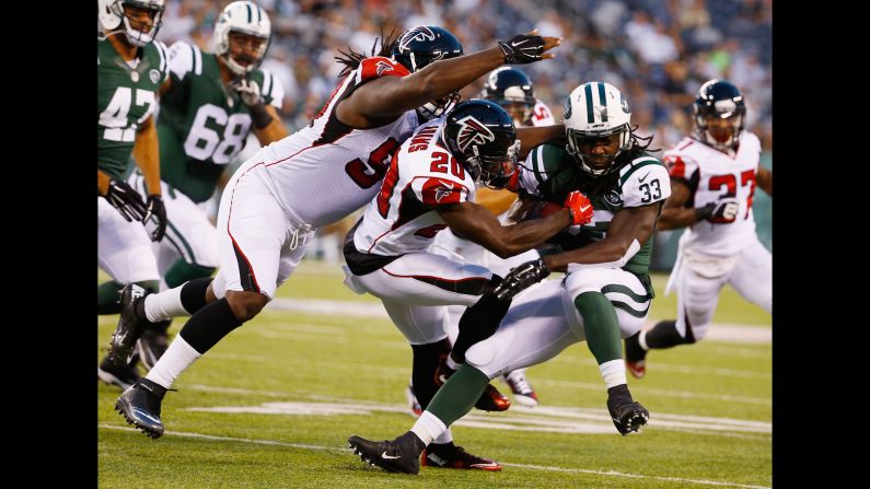 Phillip Adams of the Atlanta Falcons tackles Chris Ivory of the New York Jets during an NFL preseason game Friday, August 21, in East Rutherford, New Jersey.