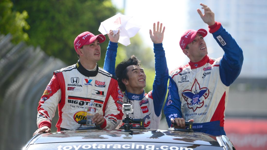 Wilson, right, rides a parade lap with Graham Rahal and Takuma Sato after finishing third in a race in April 2013.