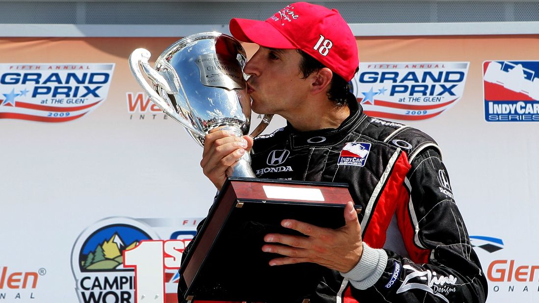 Wilson kisses a trophy after winning an IndyCar race in July 2009.