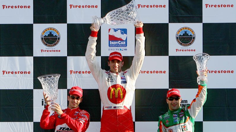Wilson, center, celebrates an IndyCar win in August 2008.