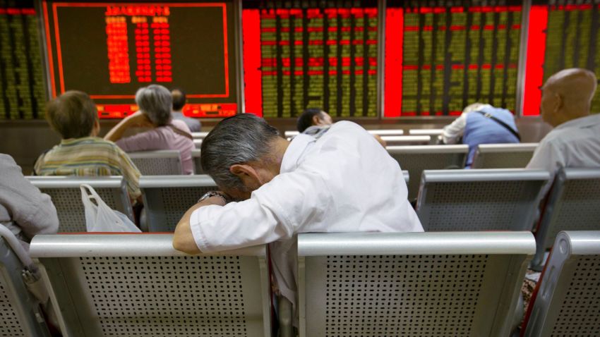 Chinese investors monitor stock prices at a brokerage house in Beijing, Tuesday, Aug. 25, 2015.  China's main stock market index has fallen for a fourth day, plunging 7.6 percent to an eight-month low.  (AP Photo/Mark Schiefelbein)