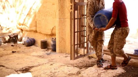 Militants are seen placing explosive devices in the temple, according to the original caption on the photo released by ISIS.