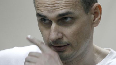 Ukrainian film director Oleg Sentsov looks out from a defendant's cage as he listens to the verdict.
