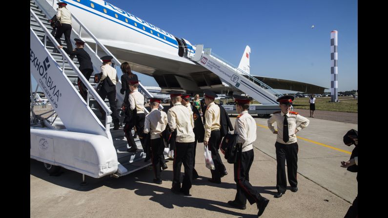 Cadets climb a ladder to see the Tu-144 supersonic jet.