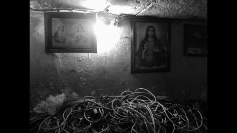 Religious paintings hang on walls inside the tunnels.