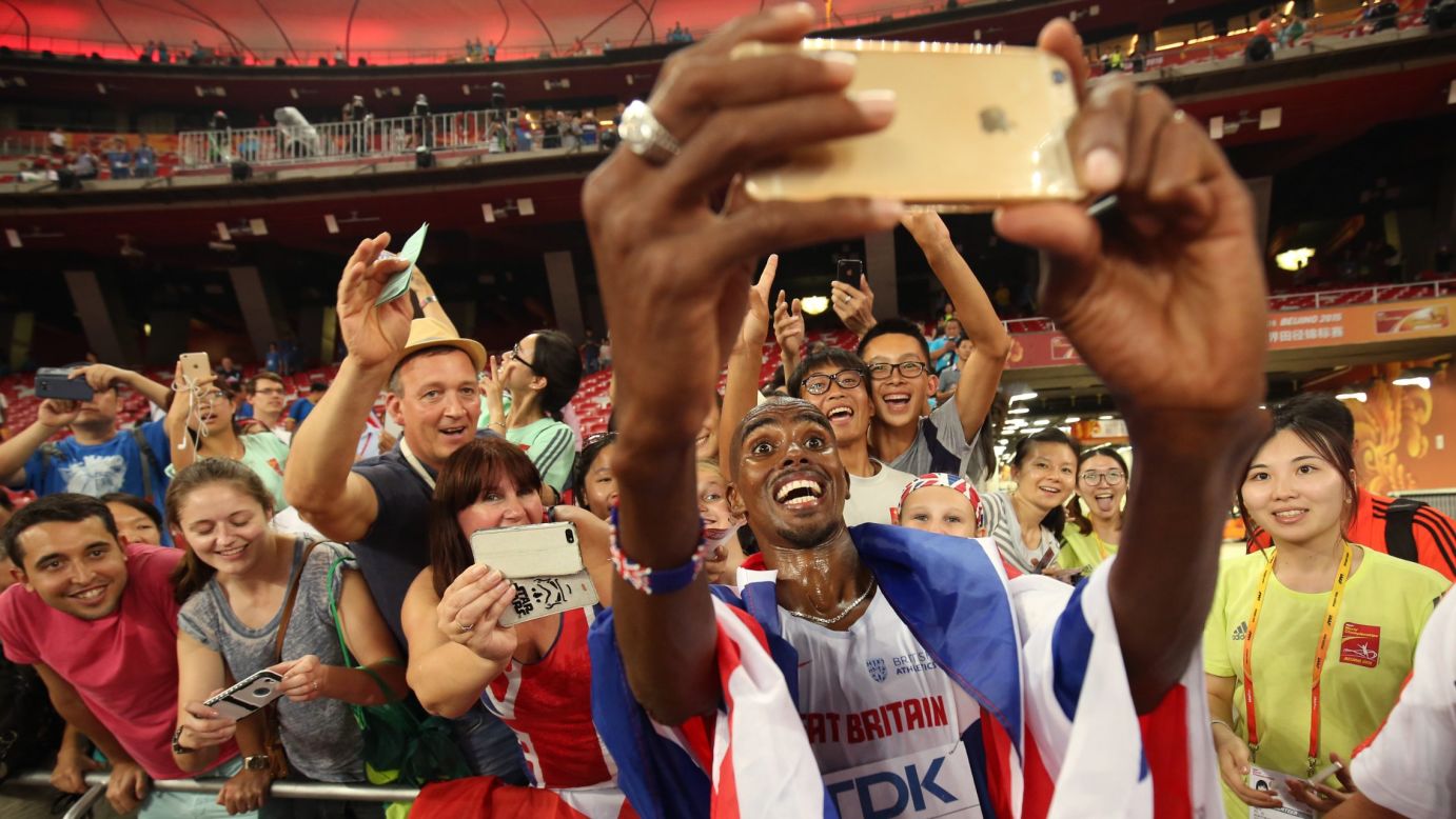 British runner Mo Farah takes a selfie with spectators after winning the 10,000 meters at the World Championships on Saturday, August 22. For the past five years, Farah has been the world's best at that distance.