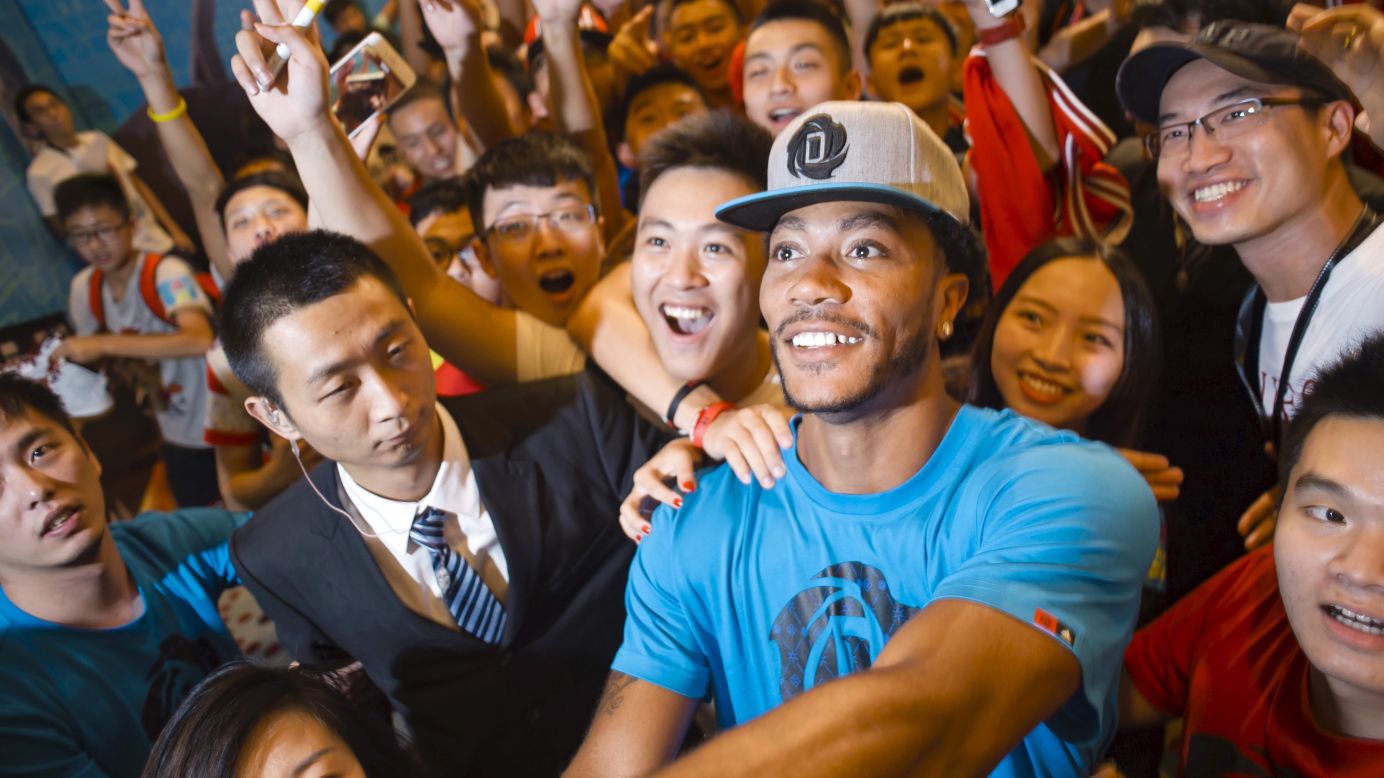 Chicago Bulls' basketball player Derrick Rose poses for a selfie with fans during an event in Guangzhou, China, on Thursday, August 21.