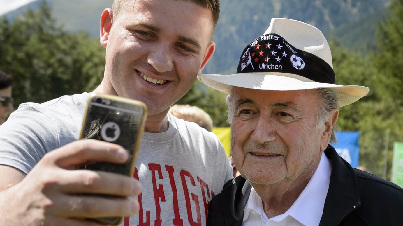 Outgoing FIFA president Sepp Blatter poses with a fan during the "Sepp Blatter Tournament" on Saturday, August 22, in Ulrichen, Switzerland, Blatter's hometown. 