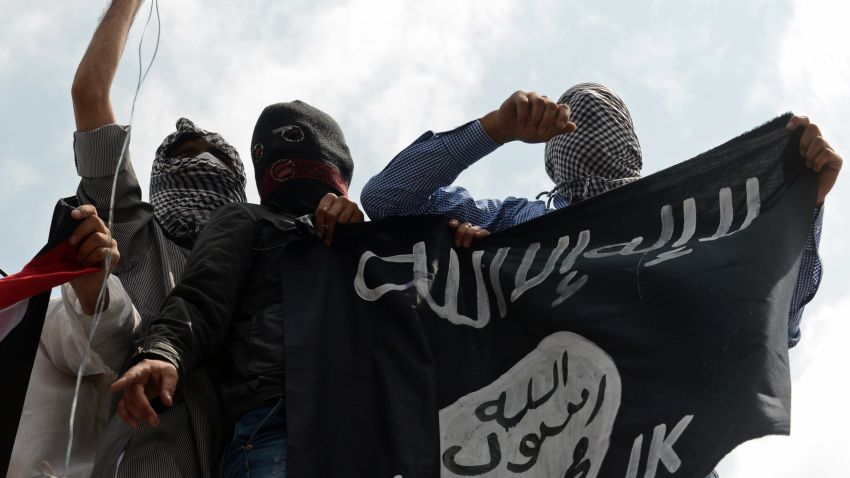 Kashmiri demonstrators hold up a flag of the Islamic State of Iraq and the Levant (ISIL) during a demonstration against Israeli military operations in Gaza, in downtown Srinagar on July 18, 2014. 