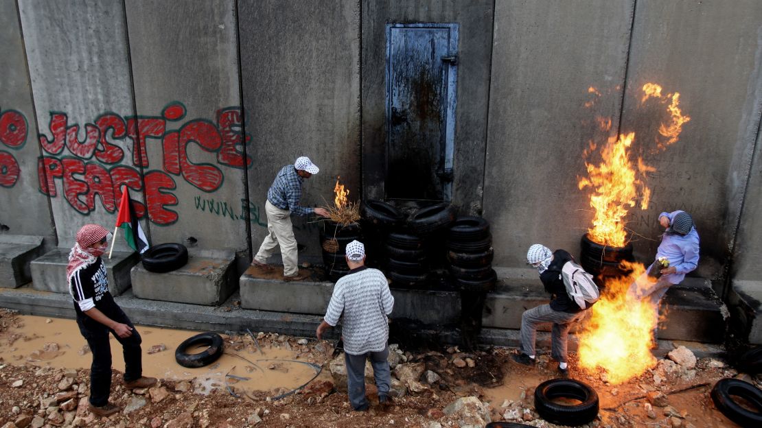 Palestinian youths in 2009 protest near a barrier in a West Bank village. 