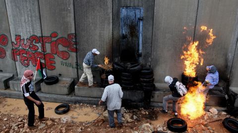 Palestinian youths in 2009 protest near a barrier in a West Bank village.