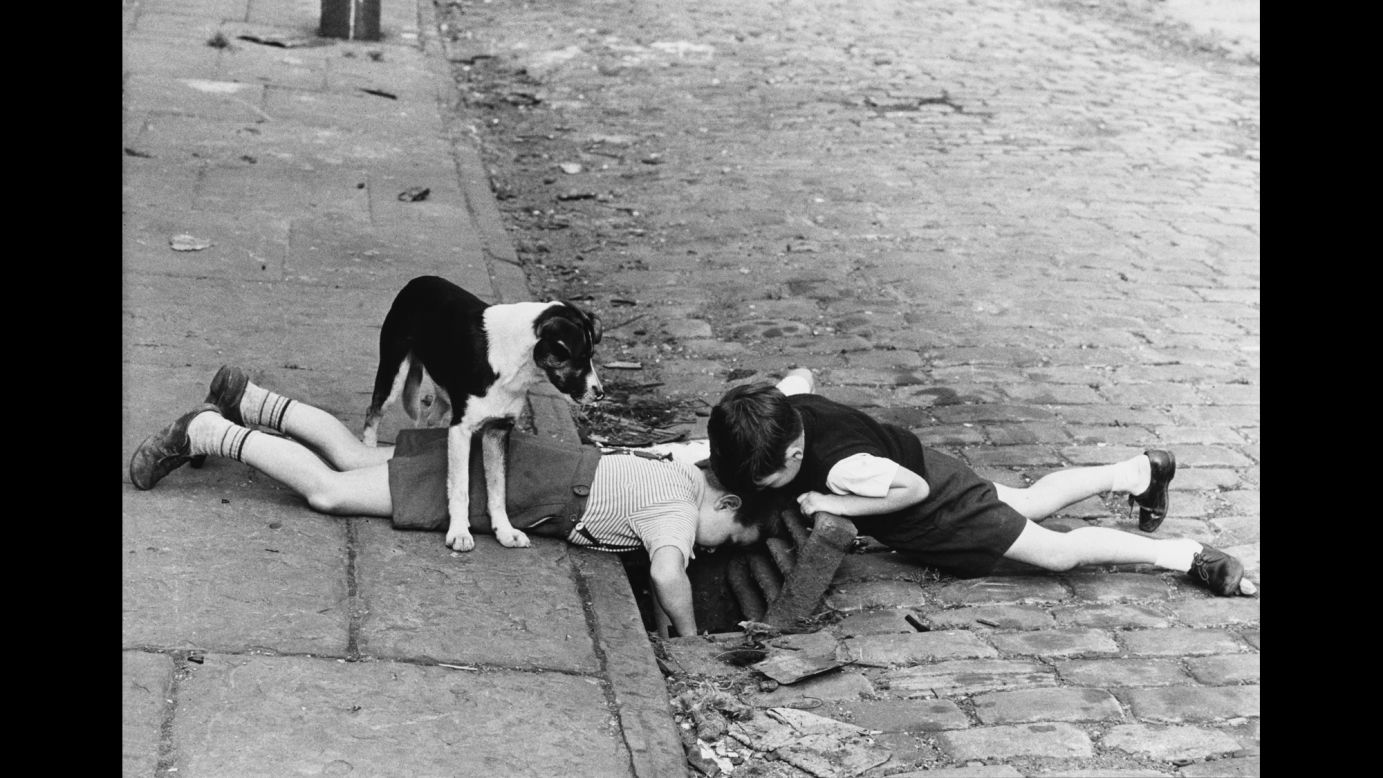 Two boys, with a faithful dog, search a sewer for something in 1963 Manchester -- a photo that looks like it could come from a 1930s "Our Gang" short. "I didn't intend to go out looking for poverty-stricken areas. What I did find was a great sense of humor," Baker wrote for the Tate.