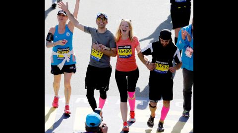 Marathon bombing survivor Adrianne Haslet-Davis crosses the finish line of the 118th Boston Marathon on April 21, 2014 in Boston, Massachusetts. 