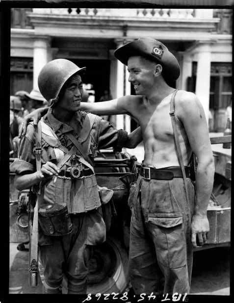 Zhang used the images for an exhibition that tells the often forgotten role of U.S. and Chinese cooperation in World War II.  Here, a British and Chinese soldier exchange greetings when the Chinese and British troops met on the Mandalay Road, Burma on 30 March 1945. 