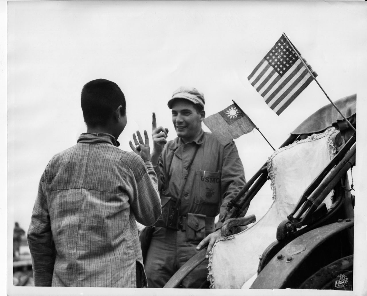 Marine Corporal Richard W. Miller bargains with a Chinese man for a lift in his rickshaw on September 30, 1945. This image was among 23,000 discovered by Chinese historian Zhang Dongpan in 2006 in the U.S. National Archives and Records Office. 