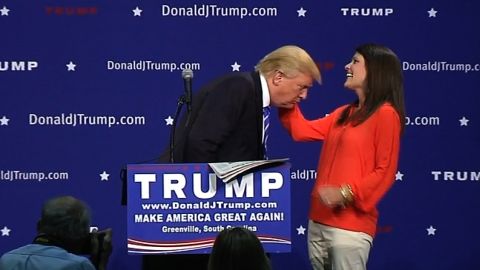 Trump asks an audience member to inspect his hair to verify it's real during an event in Greenville, South Carolina, on August 27.