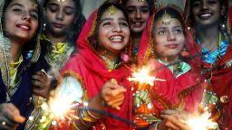Indian schoolgirls share a light moment as they play with sparklers at a function in Amritsar on October 16, 2009, on the eve of The Diwali Festival. Indians throughout the country are preparing to celebrate Diwali, the Festival of Lights on October 17. AFP PHOTO/NARINDER NANU (Photo credit should read NARINDER NANU/AFP/Getty Images)