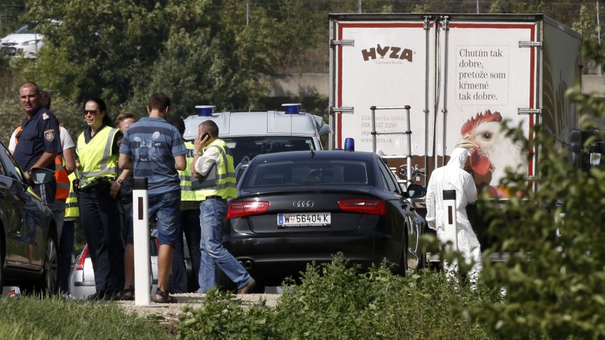 Forensic investigators work as police vehicles are parked behind a refrigerated truck parked along a highway near Neusiedl am See, Austria, on August 27, 2015. The bodies of between 20 and 50 migrants have been found in the truck on the A 4 highway in Austria, police said Thursday, the latest tragedy involving people desperately trying to reach Europe.. AFP PHOTO / DIETER NAGLDIETER NAGL/AFP/Getty Images
