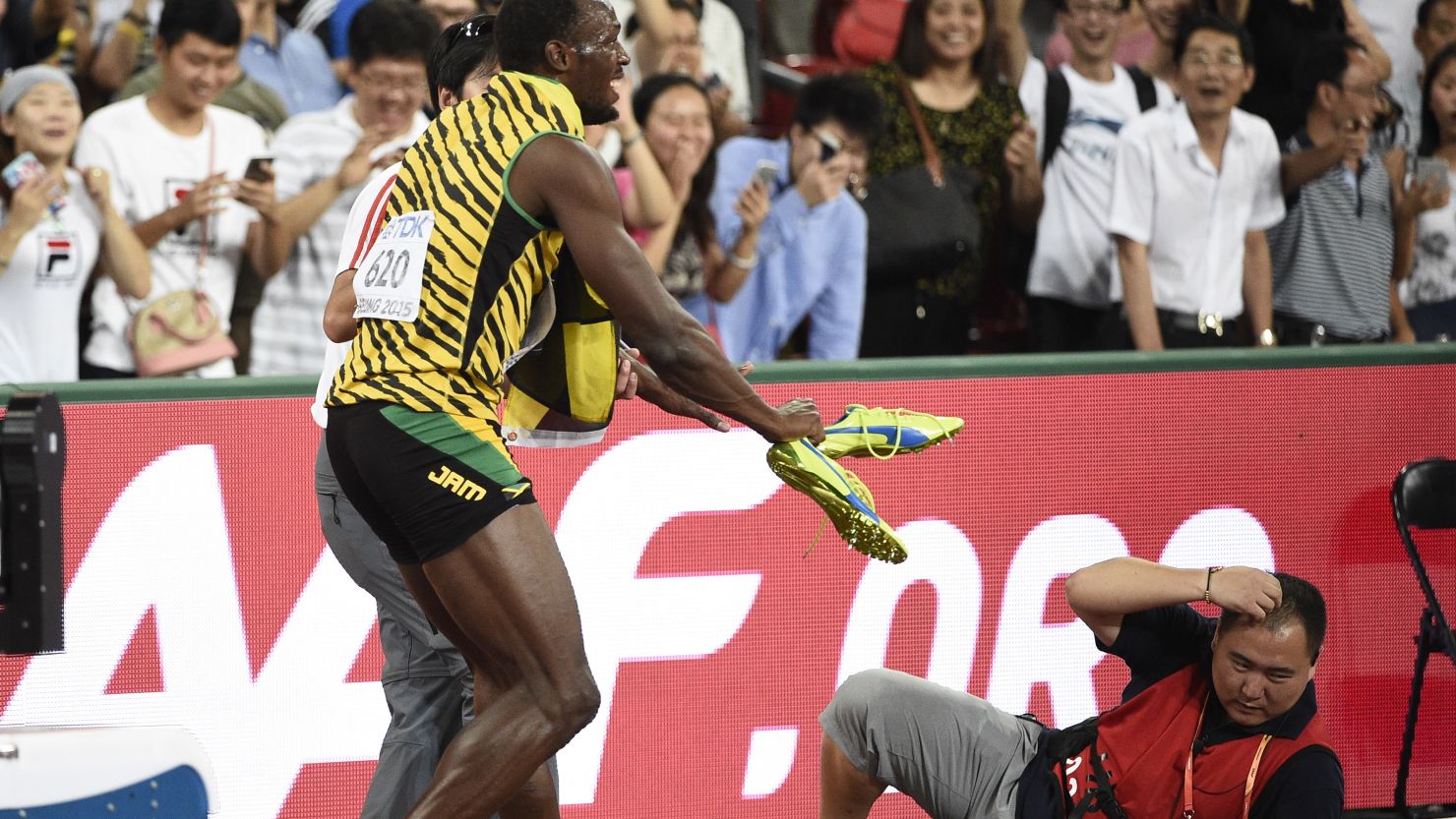 Usain Bolt reacts after a cameraman on a Segway crashes into him in Beijing on Wednesday.