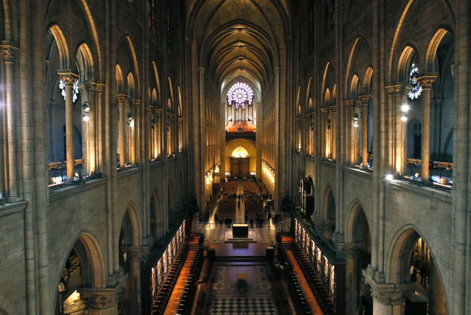 A view of the inside of the Notre-Dame de Paris cathedral. Gothic cathedrals like this encourage people to look up to the heavens -- be it through high ceilings, a raised steeple, or mounted statue -- to aid the inspiration felt when entering the building. 