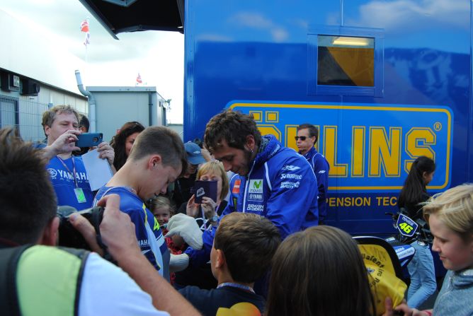 Rossi signs autographs for fans at Silverstone. 