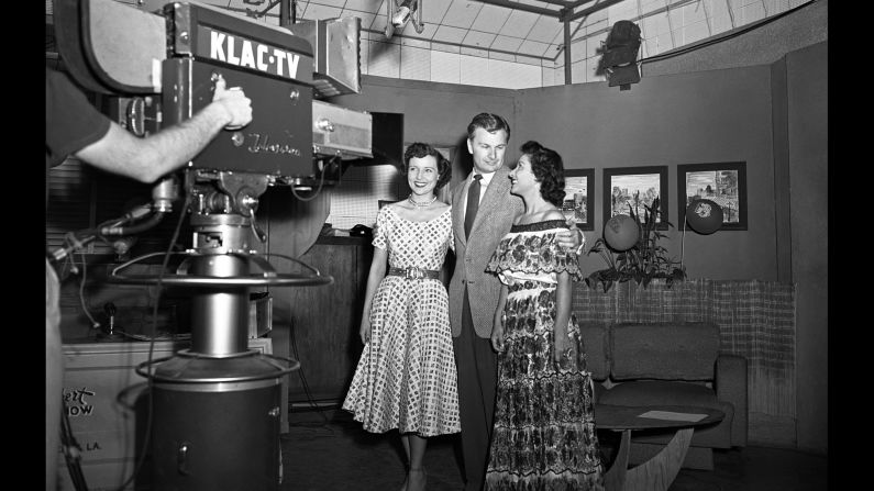 Betty White, left, actor Eddie Albert, and an unidentified woman pose in front of the a KLAC-TV camera during a broadcast of the talk show, "Hollywood on Television," in 1952. The show was "like going to television college," she said.