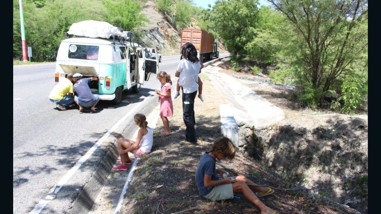 The Walkers wait along a Guatemalan highway after their Volkswagen bus breaks down.