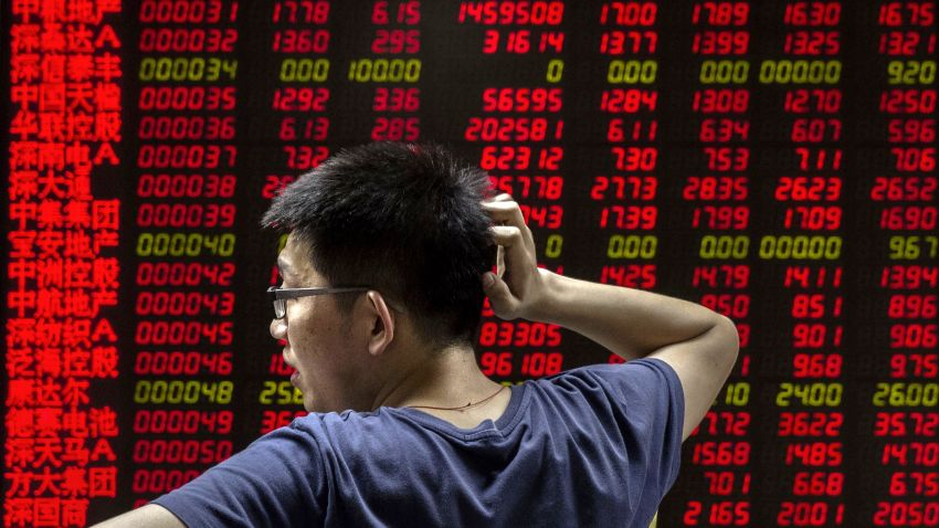 BEIJING, CHINA - AUGUST 27:  A Chinese day trader reacts as he watches a stock ticker at a local brokerage house on August 27, 2015 in Beijing, China. A dramatic sell-off in Chinese stocks caused turmoil in markets around the world, driving indexes lower and erasing trillions of dollars in value. China's government has implemented a series of top-heavy measures to manipulate a market turnaround including its fifth cut to interest rates since November. Concerns about the overall health of China's economy remain amid data showing slower growth.  (Photo by Kevin Frayer/Getty Images)
