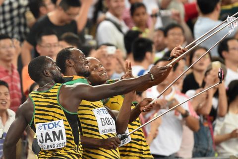 The Jamaican relay team celebrate by taking selfies with fans.