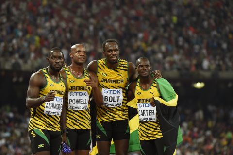 The Jamaican relay team (L-R) Nickel Ashmeade, Asafa Powell,Usain Bolt and Nesta Carter pose for photographers after winning the final of the men's 4x100 metres relay event.