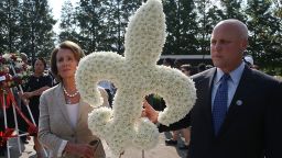 U.S. Rep. Nancy Pelosi (D-CA) (L) and New Orleans Mayor Mitch Landrieu carry a flower arrangement as they lay a wreath during an event to remember the 10th anniversary of Hurricane Katrina at the New Orleans Katrina Memorial where the remains of hurricane victims who were either unidentified or unclaimed are held in mausoleums on August 29, 2015 in New Orleans, Louisiana. 