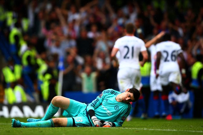 Chelsea keeper Thibaut Courtois looks despondent after being beaten.