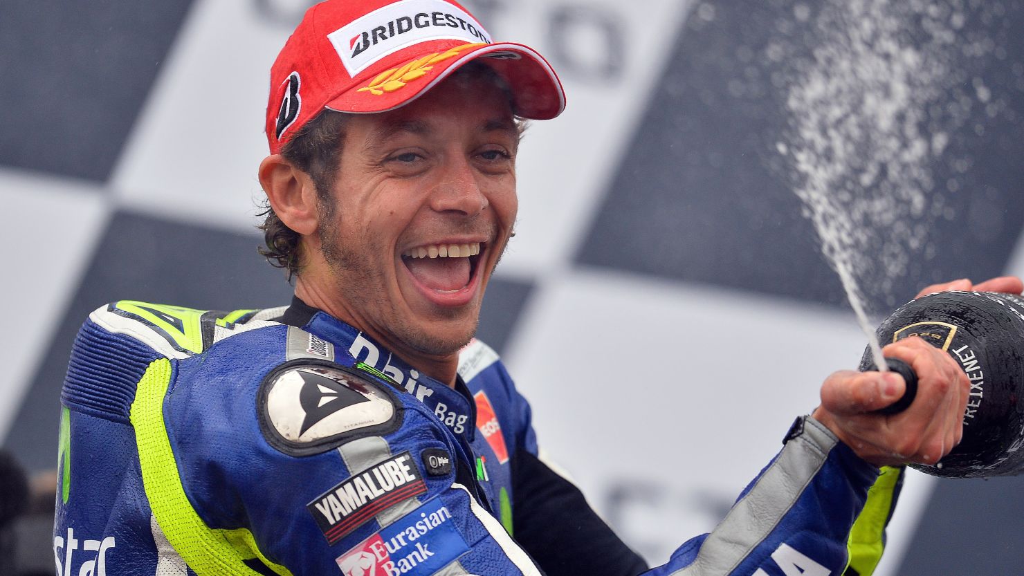 Valentino Rossi celebrates his fourth victory of the season after winning the British MotoGP at Silverstone. 