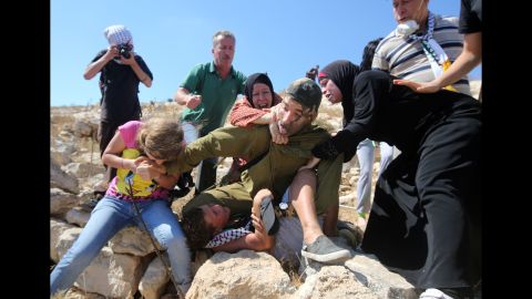 Tamimi, the boy's father, told CNN that his wife and daughter were trying to free his son and clashed with the soldier.