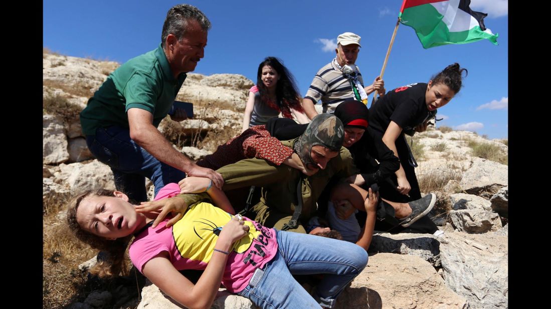 The Israeli army defended its actions, saying that people in the crowd had thrown rocks at the soldiers. "The forces decided to detain one of the Palestinians identified hurling rocks," an Israeli army spokeswoman told CNN. The army said the commander at the scene halted the arrest to avoid an escalation of the situation.
