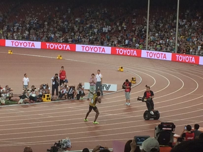 Usain Bolt pictured celebrating one-third of his triple gold. Watch out for that Segway ...