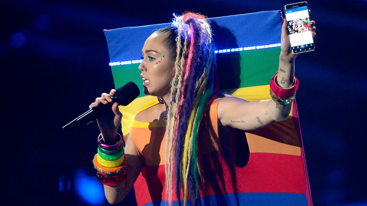 No, that's not a live-action Instagram photo. That's Miley rocking a rainbow-flag outfit that appears to be stretched over a backdrop. 