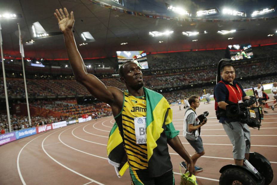 Usain Bolt celebrates his 200m gold moments before a cameraman on a Segway knocked him over at the Beijing National Stadium, also known as the Bird's Nest, on August 27, 2015.
