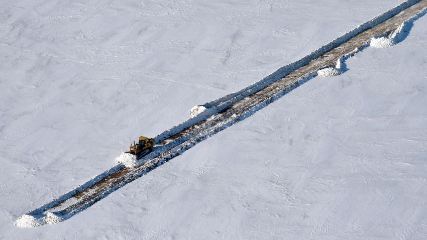 A picture taken on April 16 shows a bulldozer clearing a snow-covered road at the village of Sabetta in the Kara Sea shore line on the Yamal Peninsula in the Arctic circle, some 2450 km of Moscow.