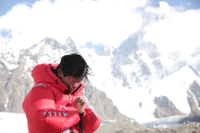 Kuriki clasps his hands, which were badly frostbitten in 2012 and required amputation of several fingers and a thumb, during his Broad Peak ascent on the border of Pakistan and China in 2014.