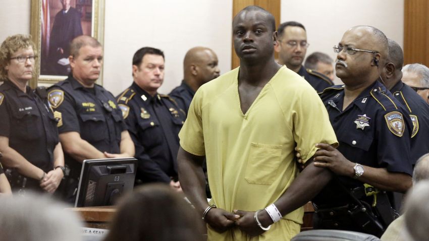 Shannon Miles is escorted out of a courtroom after a hearing, Monday, Aug. 31, in Houston. Miles has been charged with capital murder in the death of Harris County Sheriff's Deputy Darren Goforth. He is being held without bond. 