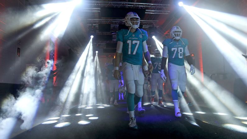 Quarterback Ryan Tannehill (No. 17) and the Miami Dolphins walk to the field for a NFL preseason game in Miami Gardens, Florida, on Saturday, August 29.