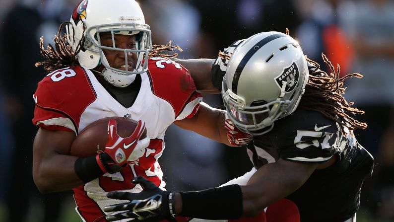 Oakland's Ray-Ray Armstrong tackles Arizona's Andre Ellington during an NFL preseason game on Sunday, August 30.