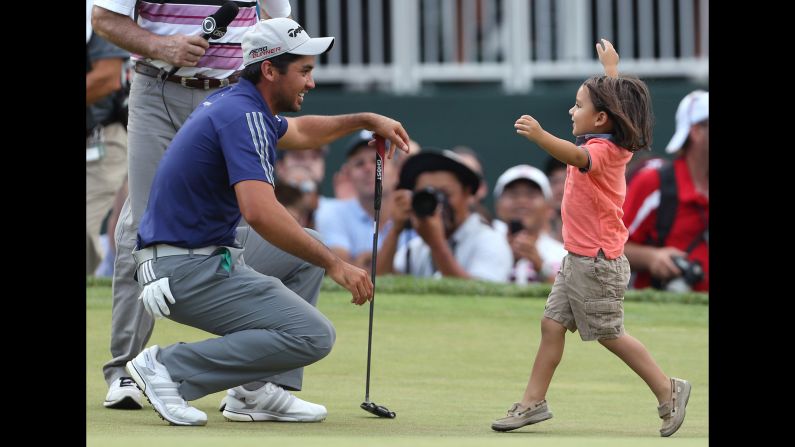 Jason Day is congratulated by his son, Dash, after winning The Barclays golf tournament Sunday, August 30, in Edison, New Jersey. Day, who won the PGA Championship two weeks ago, blew away the Barclays field by six shots.