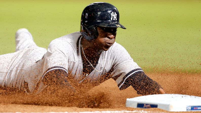 New York Yankees shortstop Didi Gregorius slides into third base during a game in Atlanta on Saturday, August 29.