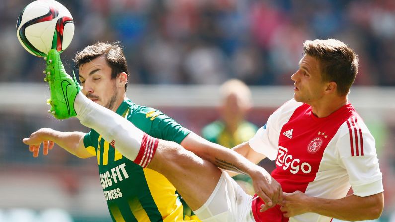 Ajax's Joel Veltman kicks a ball near ADO Den Haag's Mike Havenaar during an Eredivisie match in Amsterdam, Netherlands, on Sunday, August 30.